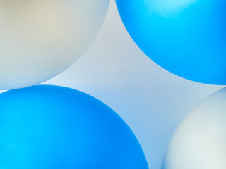 Gray background with round blue and white balls with highlights.