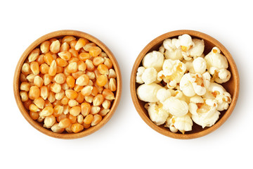 Dried corn kernels and popped popcorn in wooden bowls on white background - obrazy, fototapety, plakaty