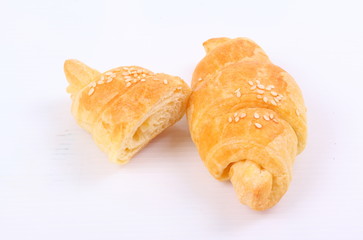 Fresh and tasty croissant on white background