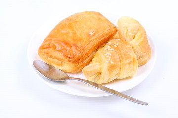 Fresh and tasty croissant on white background