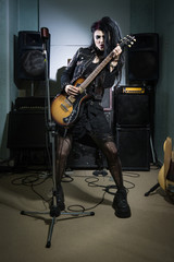 Fototapeta na wymiar Rock star playing guitar in the recording studio