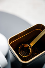 Flavoured black tea in metal tin box with a spoon