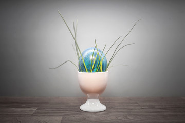 blue easter egg with grass