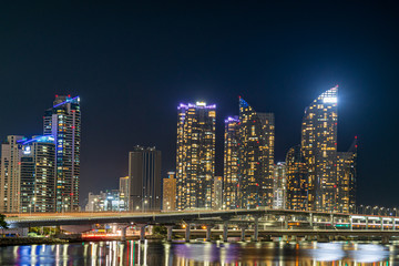 Fototapeta na wymiar The night view of skyscraper in Haeundae and Gwangan Bridge, Busan, South Korea