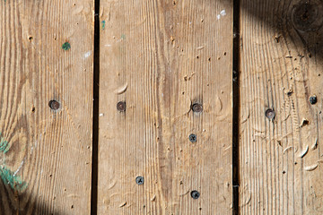 Old wood floor with nails in the sunlight 