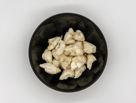 Closed Up Premium Jumbo Lump Of Fresh Blue Crab Meat In Small Black Ceramic Bowl Isolated On White