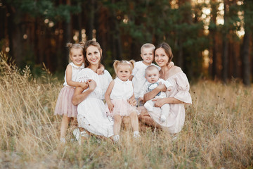 Big family is relaxing together in green nature. Mother's Day. happy family together. two moms with children. selective focus