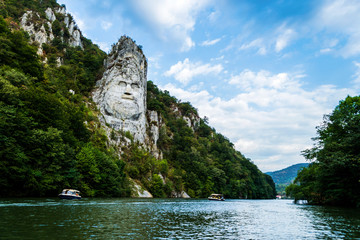 The face of the Dacian king Decebal. Panoramic view of the Danube river. 
