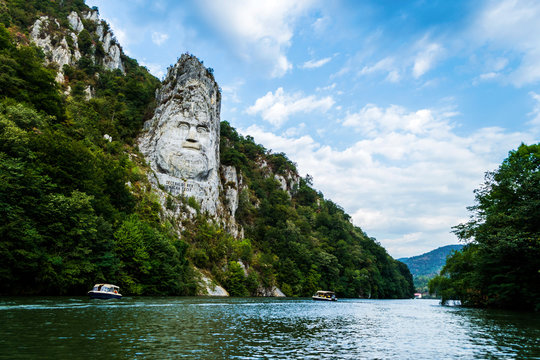 The face of the Dacian king Decebal. Panoramic view of the Danube river. 