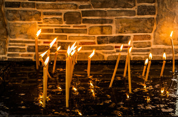 Burning candles for dead or alive people at orthodox or catholics.