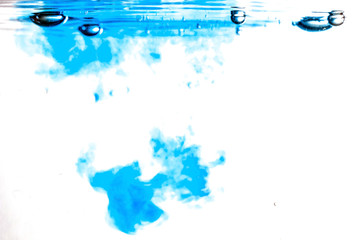 Colored ink cloud grows in water. Astract shape background.