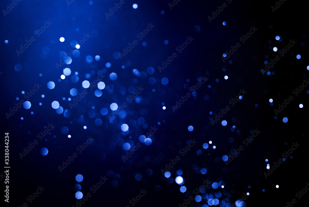 Wall mural abstract dark background with glowing blue particles.