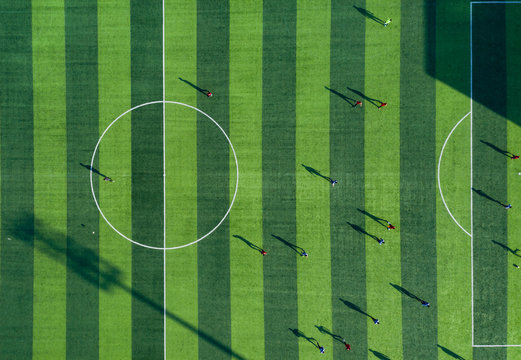 UAV Aerial Photography Of People Playing Football On The Football Field
