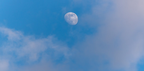 Three Quarter Moon in a Blue Sky with Clouds