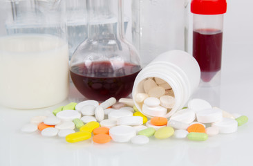 Medical pills and glassware with liquids for laboratory analysis. Laboratory medical research,...