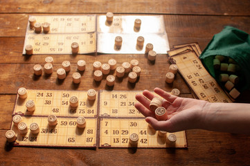 homemade family vintage interesting lotto bingo game, hand holds a bingo ball
