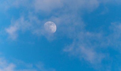 Three Quarter Moon in a Blue Sky with Clouds