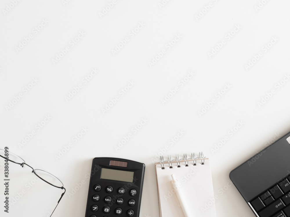 Poster top view of work from home concept with keyboard, calculator and notebook on white background, graph