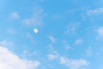 Three Quarter Moon in a Blue Sky with Clouds