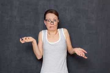 Portrait of funny shocked perplexed girl with skewed glasses