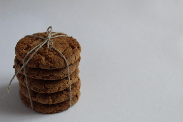 food cookies homemade round stacked on top of each other and tied with a rope in a white place with...