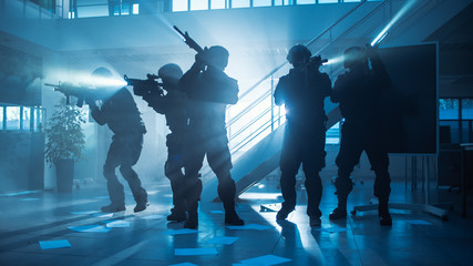 Masked Fireteam of Armed SWAT Police Officers Storm a Dark Seized Office Building with Desks and...