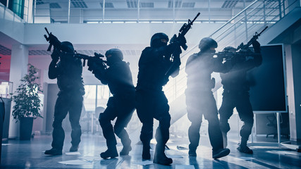 Masked Fireteam of Armed SWAT Police Officers Storm a Bright Seized Office Building with Desks and...