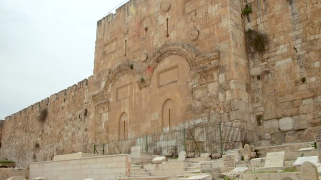 View of the Golden gates in the Old City Walls of Jerusalem in Israel. It located in an ancient Muslim cemetery. Tilt up.