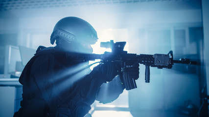 Close Up Portrait of Masked Squad Member of Armed SWAT Police Officers Who Storm a Dark Seized...