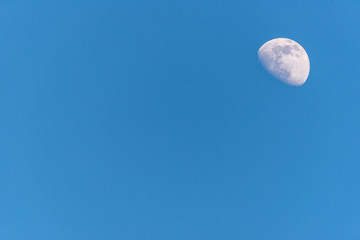 Three Quarter Moon in a Blue Sky