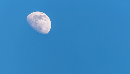 Three Quarter Moon in a Blue Sky