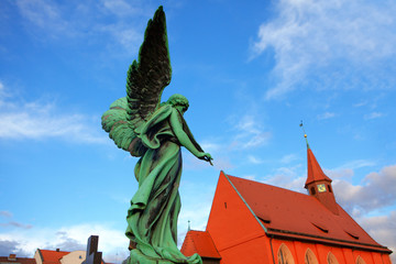 Angel statue on a cemetery and church view
