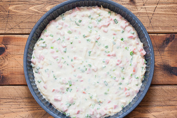 Step-by-step preparation of a pie with sausage, cheese and green onions, step 5 - raw dough for a...