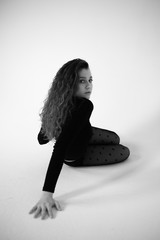 Stylish beautiful dancer wearing black leotard and black tights with polka dot on the white backgroud