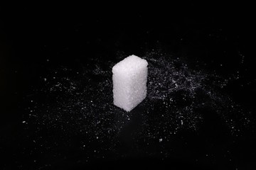 Sugar cube on black background.