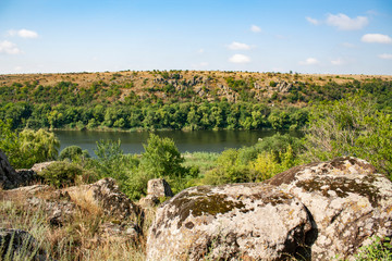 Obraz premium canyon of the Southern Bug River in southern Ukraine. Riverbank with dangling granite stones.