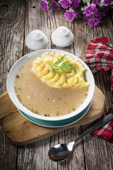 Pure white borscht served with mashed potatoes.