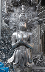 Statue of Bodhisattva with Nagas of the Wat Sri Suphan Temple, known as the Silver Temple, in Chiang Mai, Thailand