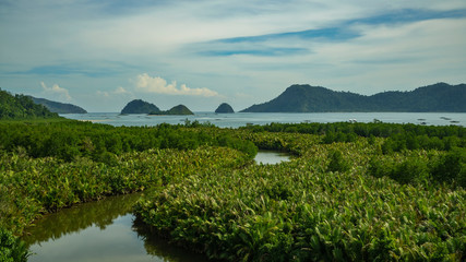 Puncak mandeh interesting viewpoint many small islands in distance and pristine jungle around in West Sumatra, Indonesia