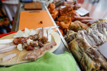Shallow depth of field (selective focus) image with traditional Romanian meat products, mostly from pork, on display in a market.