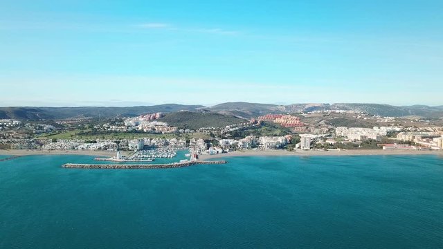 Beautiful Aerial panoramic view of "Puerto de la Duquesa" and city of MANILVA- Malaga SPAIN. Yachts and boats docked in the Harbour. Luxury Apartment Urbanisation and Restaurants. Empty beaches. Down
