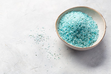 Home Spa. Blue sea salt with seaweed for the body in a bowl on a light background.