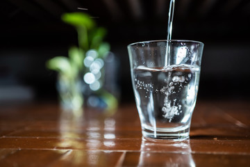 Pouring drinking water into a glass