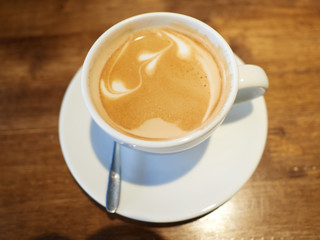 A cup of latte with some latte art