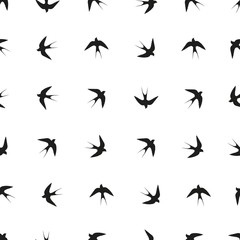 Vector seamless pattern. Black silhouette of a swallow.