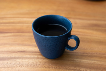 cup of coffee on wooden table