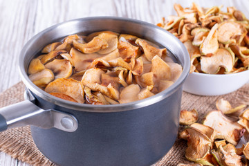 Compote with dried fruits from apples on wooden table