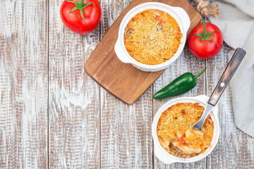 Spicy tomato jalapeno mac and cheese with mini penne pasta, in baking dish, horizontal, copy space, top view