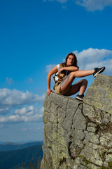 Woman traveler looking at amazing mountains and forest. Travel concept, space for text. Atmospheric epic moment Travel recreational outdoor activity concept. Camping.