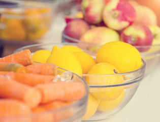Fresh apple, lemons and carrots in the background. Fruit for making fresh juice.